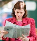 Image of woman reading newspaper